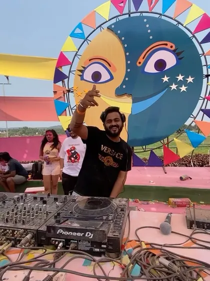 Posing at my console in Goa. The colorful, festive backdrop perfectly captures the spirit of a destination Holi party.