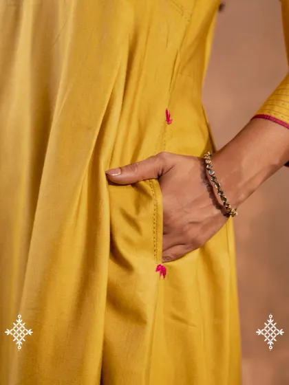 We believe clothes should be as practical as they are beautiful. This close-up shows the discreet side pocket on our Ruhani Yellow Pleated Kurta, a small detail designed for the needs of real women.