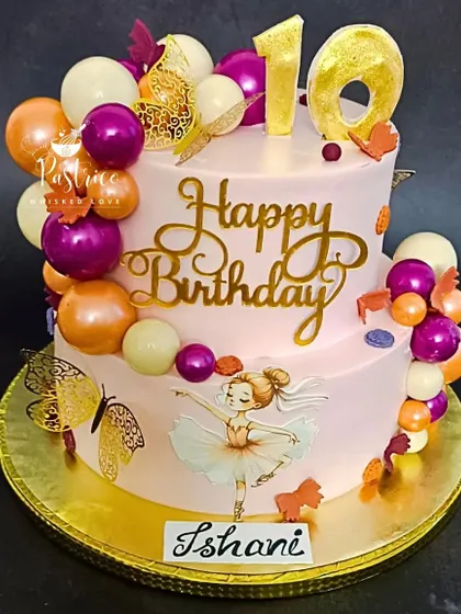 A grand two-tiered cake for a 10th birthday, featuring a ballerina, colourful spheres, and golden butterflies.