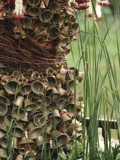 The pillar of bells seen in natural daylight, showing the beautiful texture and craftsmanship of this unique decor element.