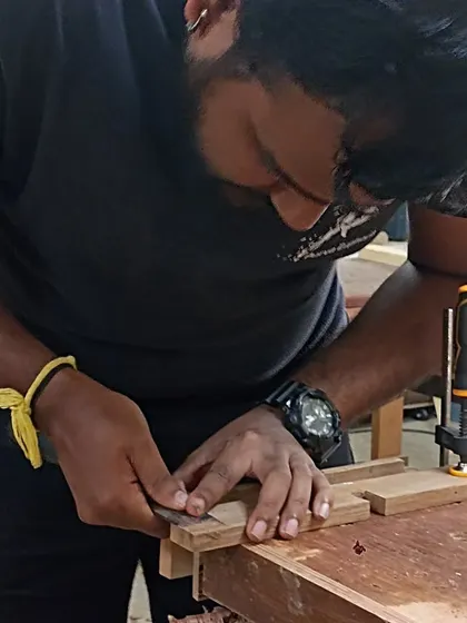 Tejus using a marking gauge to scribe a line for a tenon. Accurate marking is the first step to accurate joinery.