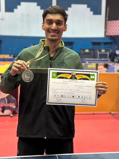 Deepit Patil proudly displays his silver and gold medals won at the All India Public Sector Table Tennis Tournament, where he represented the Airport Authority of India team.