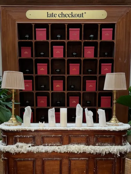 We even integrate the venue's existing features, like this 'late checkout' shelf, into the decor with themed elements like faux snow and candles.