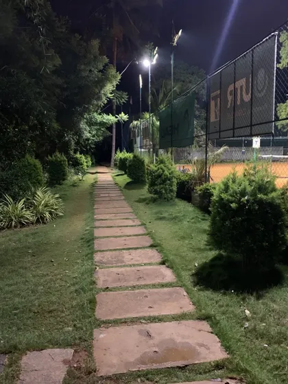 Your game starts here. Even the walk to the courts is part of the experience, with landscaped paths surrounded by greenery that set us apart from the usual city tennis scene.