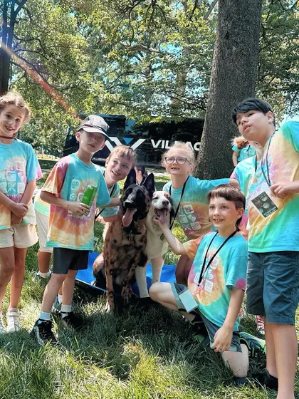 Our therapy dogs in training getting lots of love from the kids. Positive interactions like this are crucial for building confident, friendly dogs.