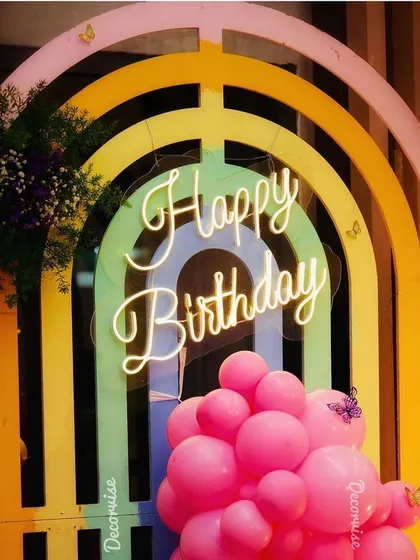 This rainbow-themed backdrop with a neon sign is perfect for first birthdays and other milestone celebrations. The bright colours and modern lighting create a joyful and photogenic setting for the party.
