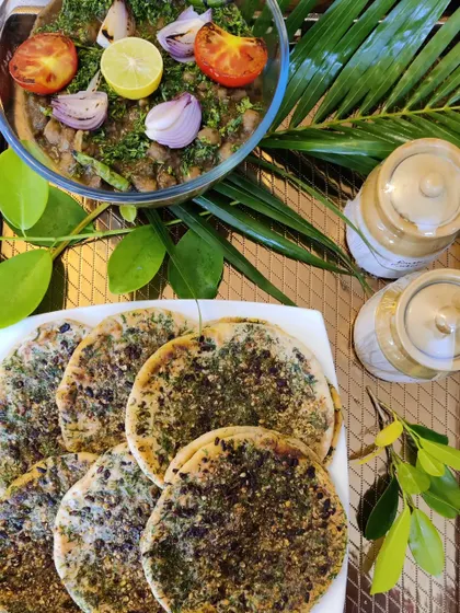 A classic North Indian comfort meal of Amritsari Kulcha served with a hearty bowl of homemade Chana Masala, garnished with fresh herbs and onion.