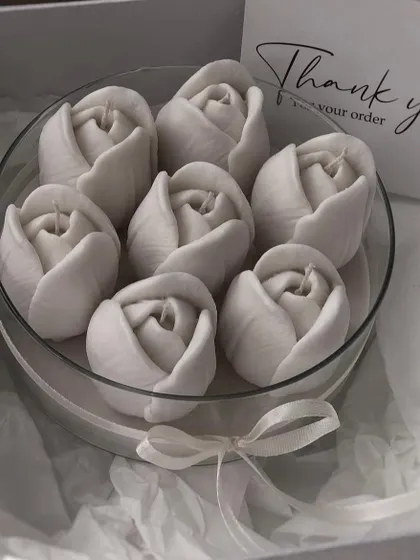 A set of my white tulip floating candles, beautifully packaged in a round box. They create a serene and dreamy ambiance.