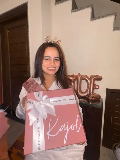 The joy on her face says it all. Here's a happy bride-to-be holding her personalized "Kajol" bridesmaid box during her bridal shower celebration.