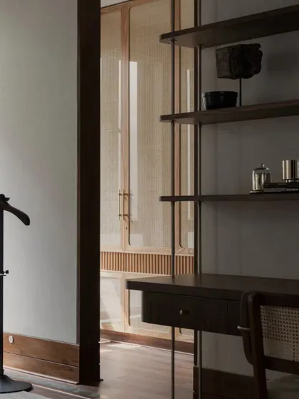 An identical shot of the desk and cane wardrobe, highlighting the clean lines and beautiful craftsmanship of the custom furniture.