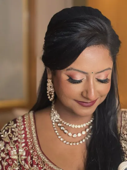 A close-up of the eye makeup. The soft, shimmering tones and fluttery lashes create a look that is both romantic and glamorous.