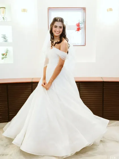 A full-length portrait of the bride, twirling in her beautiful gown. This shot captures the joy and elegance of the bride on her special day.