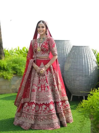 For this beachside wedding, I created a classic bridal look with a modern twist. The red lehenga stands out beautifully against the natural backdrop, with makeup that is both elegant and weather-proof.