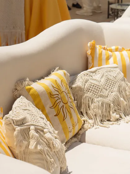 Custom-designed cushions with sun motifs and macrame details added a personal and bohemian touch to the Mehendi lounge seating.