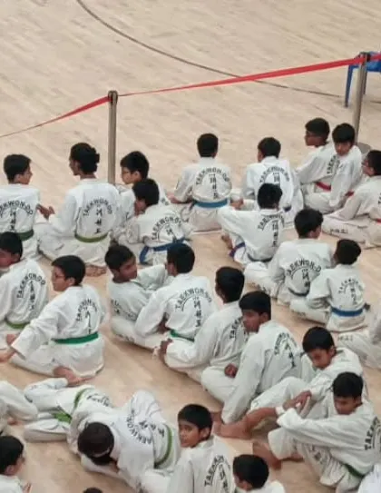 An overhead shot of students seated and ready for instruction at a competition.