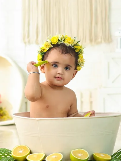 A sweet and gentle moment in the milk bath. The yellow floral crown adds a beautiful pop of color to this serene portrait.