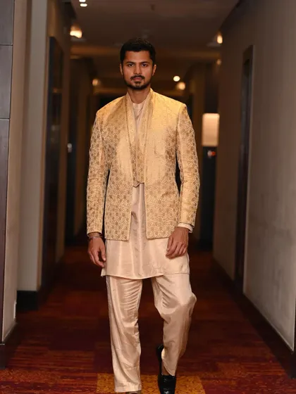 Walking down a hotel corridor in a full ethnic ensemble, creating a sense of movement and narrative for this "Desi vibes" look.