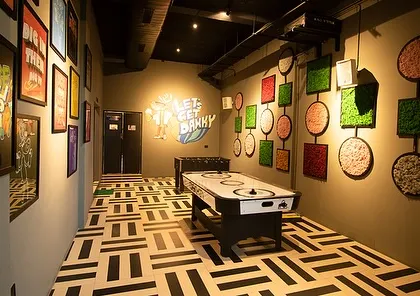 The game room at Dank, where we used preserved moss art on the walls. This is a low-maintenance way to bring color, texture, and a natural element into an indoor recreational space.