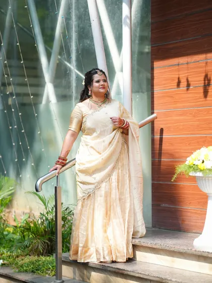 Swetha looking resplendent in her golden tissue half saree, a timeless and elegant choice.