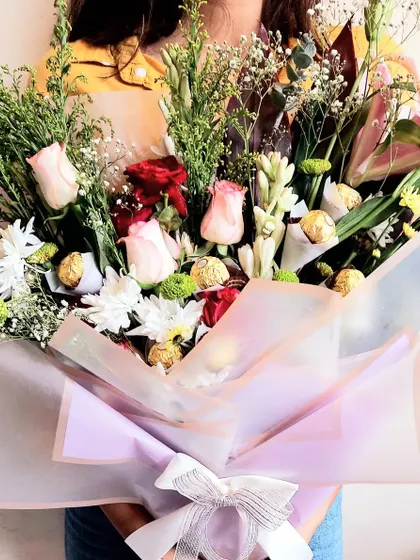 Sometimes, the best way to send love is with flowers and chocolates. This stunning bouquet combines fresh, vibrant flowers with delicious Ferrero Rocher chocolates.
