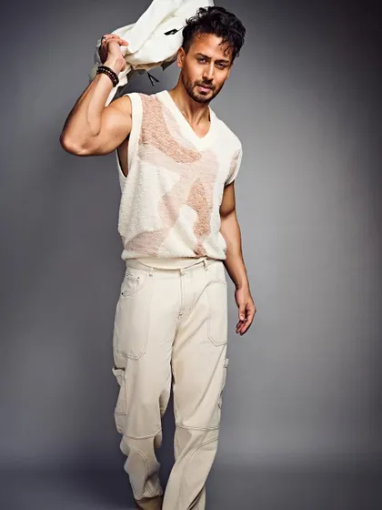A relaxed, neutral-toned look for Tiger Shroff. The sweater vest and cargo pants combination is a great example of elevated casual wear.