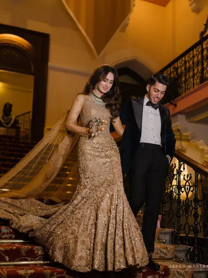 A candid moment on the stairs. The groom's smile and the bride's graceful movement create a dynamic and happy portrait.