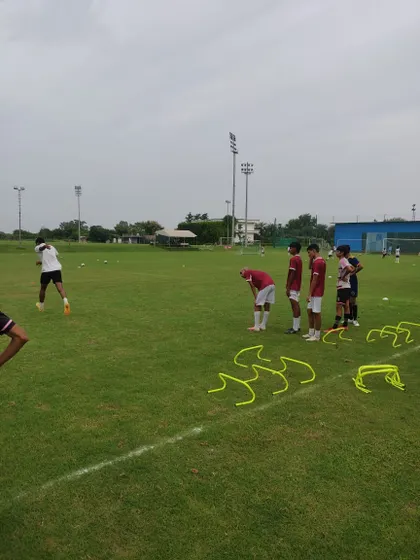 A moment of focus during a fitness day, with players preparing for hurdle and agility drills. This is where the grind happens.