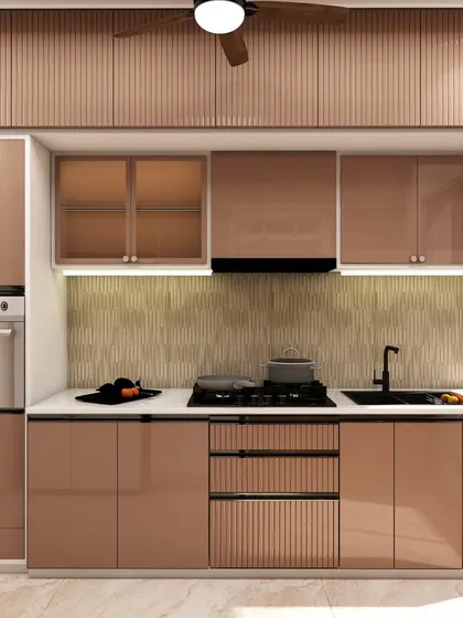 The cooking area of the copper-toned kitchen, with a built-in oven and hob, demonstrates a sleek and integrated design approach.