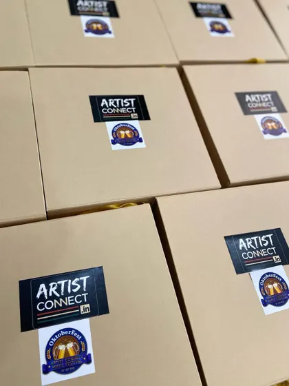 Boxes of 'Artist Connect' Oktoberfest invites, branded with custom stickers and ready to be sent out to influencers.