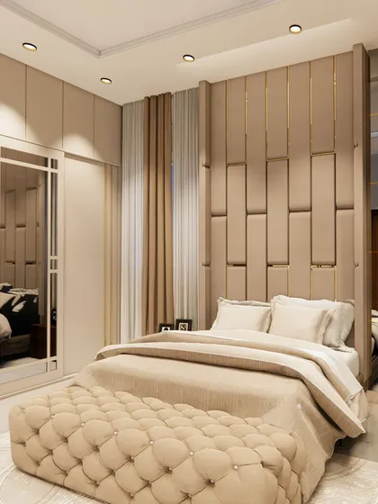A render of a luxurious bedroom in a neutral beige palette. The design includes a tufted bench, a padded headboard with gold accents, and ample mirrored surfaces to enhance the sense of space.