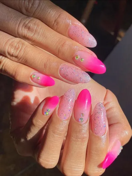 A vibrant pink ombré with a "sugar" glitter top coat and a few scattered rhinestones. It's fun, sparkly, and perfect for summer.