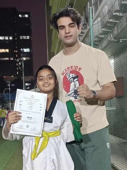 Another proud student with her certificate and new belt. We celebrate every step of the journey.