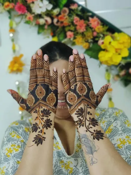 A creative backhand henna design with a bold, dark-fill floral vine. This was inspired by a Pinterest find and customized for my client.