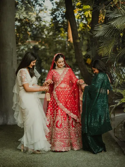 The bride shares a moment with her bridesmaids, who help with the final touches on her kalire. A beautiful portrait of friendship.