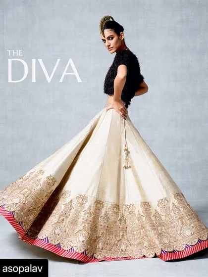 This ivory and gold lehenga offers a unique take on bridal wear. The skirt, featuring intricate architectural embroidery, is paired with a contemporary feathered top, showing how I can blend traditional craftsmanship with avant-garde elements.