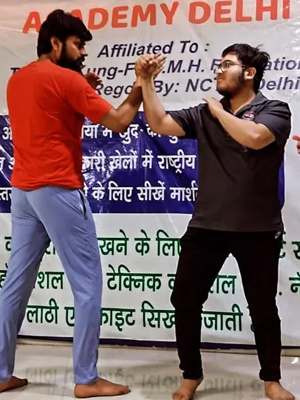 A student squares up with me, practicing hand-to-hand blocking techniques. This is fundamental for learning to read an opponent's moves.