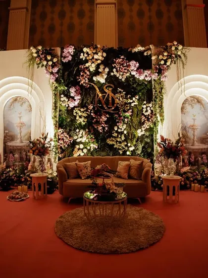 The same garden stage design, but with different lighting to create a warmer, more dramatic mood for an evening event.