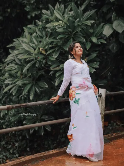 A series of peaceful portraits taken at a temple. The model's white saree contrasts beautifully with the intricate stone architecture, creating a sense of calm and serenity.