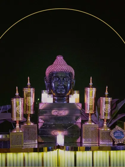 A striking buffet centerpiece featuring a Buddha head and ornate golden urns. This setup demonstrates our ability to create a powerful and memorable visual statement.