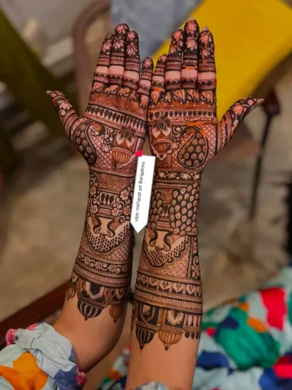 A duplicate of image 8, showing a full-hand design with peacock and kalash motifs.