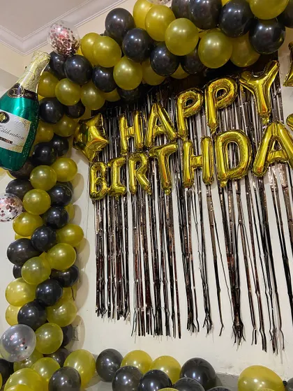 A detailed shot of the balloon arch and foil curtain backdrop.