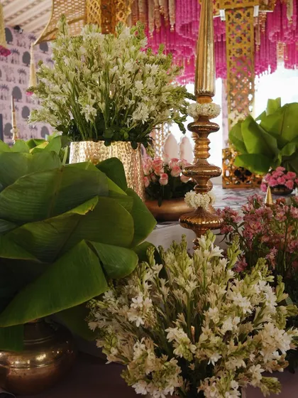 Detailed shot of the mandap, showing the lush tuberose arrangements in brass vases and other traditional elements that added to the richness of the design.