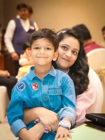 A warm and gentle portrait of a mother holding her son in her lap.