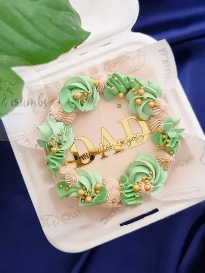 A Father's Day bento cake in a lovely mint green and beige color scheme. The gold "DAD" topper adds a touch of elegance.