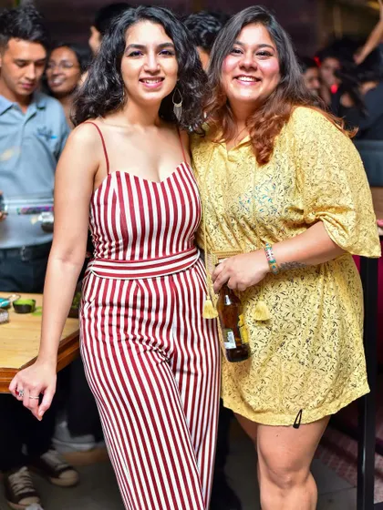 Two friends in stylish outfits, enjoying the good vibes and good company.