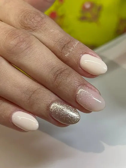 An elegant and simple combination of nude, sheer pink, and a brilliant gold glitter nail.