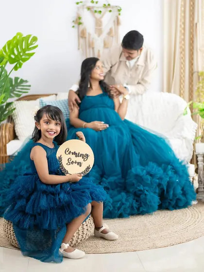A new member is joining the family, and we made sure big sister was part of the announcement. We love creating these coordinated family portraits, providing matching gowns for both mom and daughter to make the moment extra special.