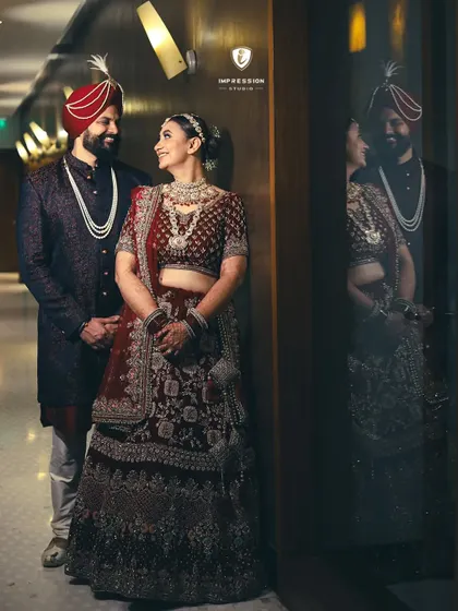 A beautiful portrait of the couple sharing a look of love, with their reflection adding depth to the image.