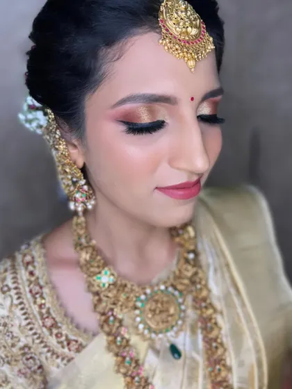 Getting you Muhurtham-ready with a focus on glowing skin and beautiful, warm-toned eyeshadow. This look is all about enhancing natural beauty.