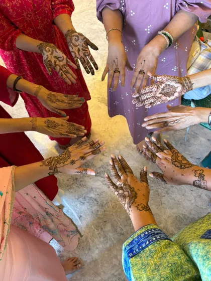 A fun shot of a group of friends showing off their different mehndi designs during a Karwachauth party.